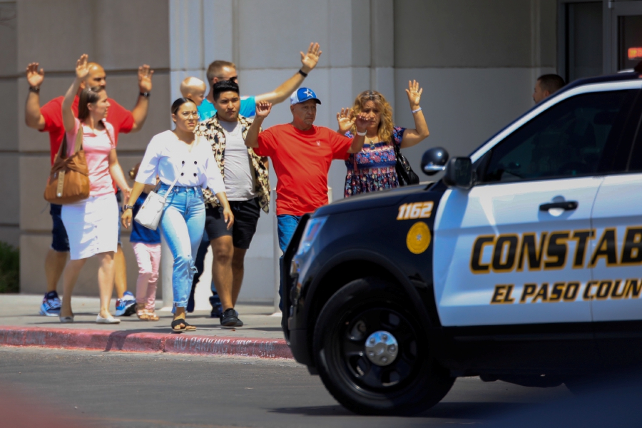 Shoppers exit with their hands up after a mass shooting at a Walmart in El Paso, Texas, U.S. August 3, 2019. (REUTERS/Jorge Salgado)