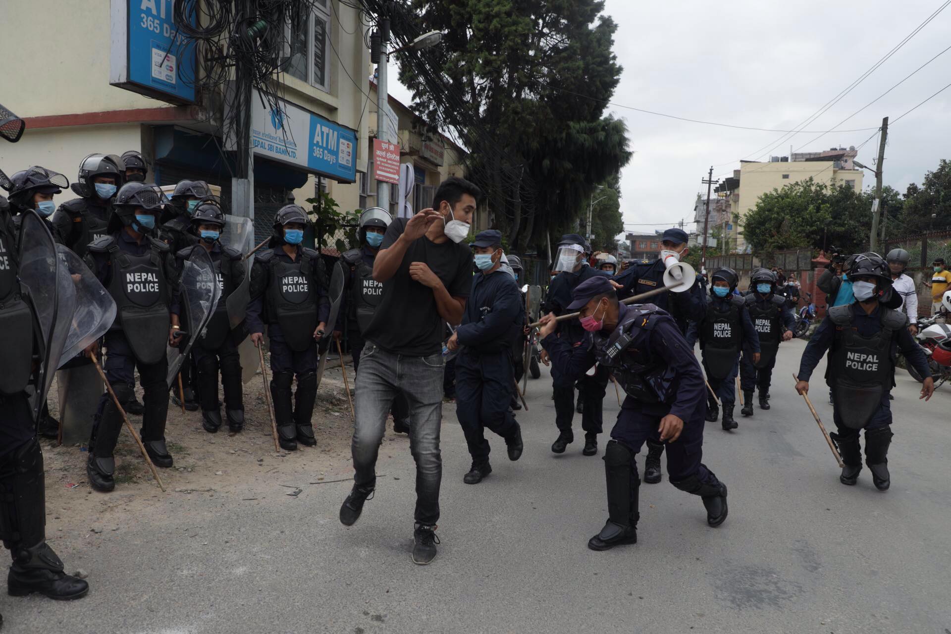 Police use force to disperse protesters demanding reinstatement of ex ...